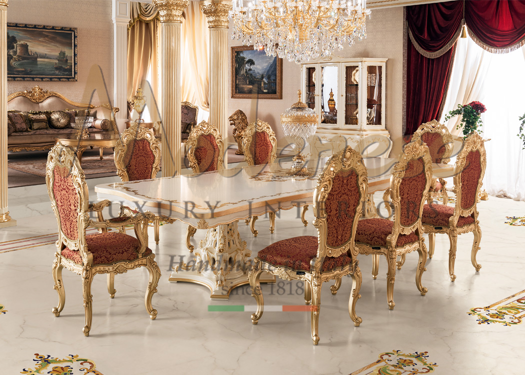 Royal red fabric Modenese Interiors dining room with central rectangular hand painted table and 8 hand carved classic chairs